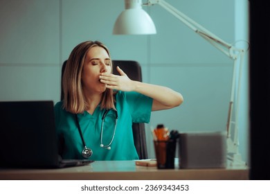 
Tired Doctor Yawning Covering her Mouth Sitting at the Desk. Sleepy medical practitioner working in a night shift 
