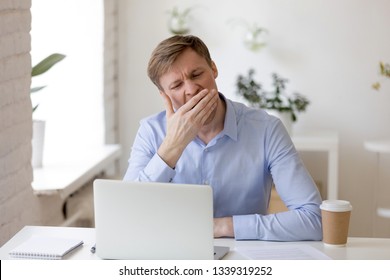 Tired Drowsy Bored Businessman Yawning At Workplace Near Laptop, Boring Work, Dead End Job, Overwork Extra After Hours, Lack Of Sleep, Insomnia Consequences, Need Rest, No Energy, Monday