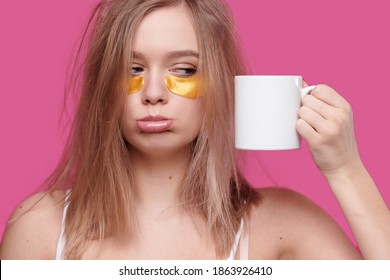 Tired And Drunk Woman With Hangover Put Patches On The Eyes Holding White Cup Of Coffee