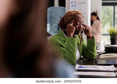 Tired Employee Having Headache At Work, Rubbing Temples, Exhausted Woman In Start Up Company Coworking Space. Office Worker Suffering From Migraine Symptom, Overworked Person Feeling Unwell