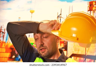 Tired engineer worker hard work fatigue male staff at work hot weather