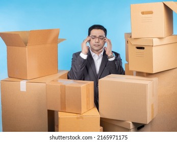 Tired entrepreneur. Business man among boxes. Man surrounded by parcels. Entrepreneur suffers from overwork. Concept of tired businessman can not cope with orders. Tired guy in business suit