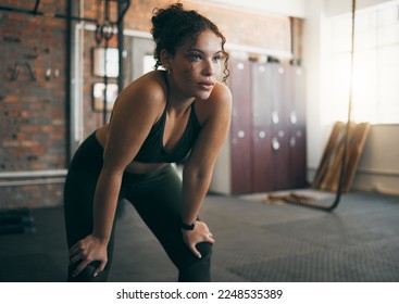 Tired, exercise and woman at gym after fitness workout or training for health and body wellness. Young sports female or athlete resting on break while thinking about goals, progress and performance - Powered by Shutterstock