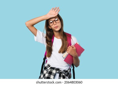 Tired exhausted caucasian smart schoolgirl teenager pupil student feeling sad after school overload, homework, remote distance education, e-learning isolated in blue background