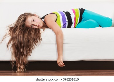 Tired Exhausted Lazy Little Girl Lying On Sofa At Home. Sleepy Kid Resting Relaxing On Couch.