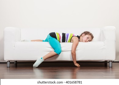 Tired Exhausted Lazy Little Girl Lying On Sofa At Home. Sleepy Kid Resting Relaxing On Couch.