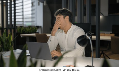 Tired exhausted overload overworked fatigued Caucasian business man boss male office worker employer manager businessman working with laptop computer online yawn want sleep stretching yawning stretch - Powered by Shutterstock