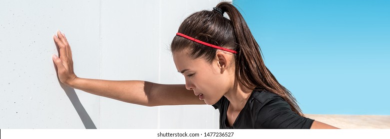 Tired Exhausted Runner Fit Woman Panoramic Banner Of Asian Athlete Leaning On Wall Dehydrated Of Heat Exhaustion Breathing Hard With Cramp Or Pain Panorama.