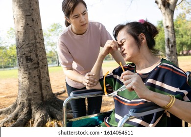 Tired Exhausted Senior Woman With Wheelchair Suffer From Strong Eye Pain Feel Sore,injury,hurt Eye Strain Headache From Eyeglasses,problem With Vision,burning,irritation,dry Eye Fatigue In Sunny Day