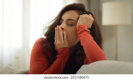 Tired exhausted young Caucasian sleepy woman yawn bored female girl yawning hand over mouth homeowner stretching arms housewife stretch sitting couch sofa indoors living room. Boredom health problem - Powered by Shutterstock