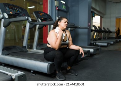 Tired Fat Woman At The Gym And Using A Towel To Wipe Her Sweat After Running On The Treadmill 