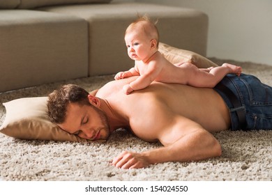 Tired Father. Little Baby Lying On Fathers Back While Man 