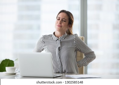 Tired Fatigued Businesswoman Worker Rubbing Back Feeling Pain In Kidneys Suffers From Lower Lumbar Backache After Sedentary Computer Work Sitting In Incorrect Posture On Uncomfortable Office Chair