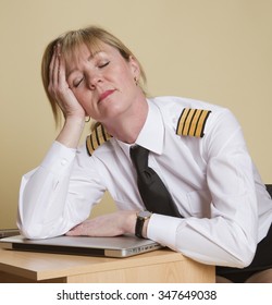 Tired female airline pilot wearing insignia of a captain 
