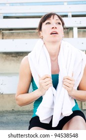 Tired Female Athlete With Towel