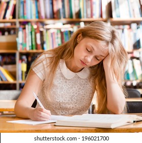 tired female student n library - Powered by Shutterstock