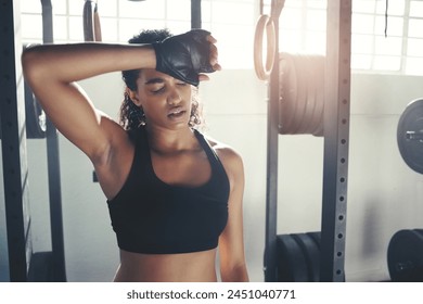 Tired, fitness and woman with sweat in gym for intense training, exercise and bodybuilder workout. Sports, athlete and person breathe, rest and on break for wellness, muscle and health in morning - Powered by Shutterstock