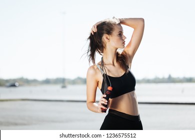 Tired Fitness Woman Wipes Sweat From Forehead, Feels Fatigue After Active Cardio Workout, Does Fitness Exercise, Has Serious Expression Into Distance