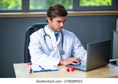 Tired And Focused Doctor Working Hard At His Laboratory Or Desk, Collecting Data And Analyzing Some Blood Test