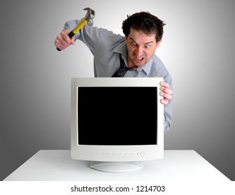 Tired, Freaked-out Business Man Preparing To Smash A Computer Monitor With A Hammer.