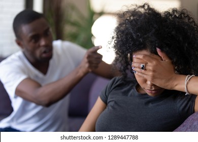 Tired frustrated african wife ignoring angry black despot husband arguing blaming upset woman of problems, jealous man shouting at sad girlfriend, family fight and controlling boyfriend, disrespect