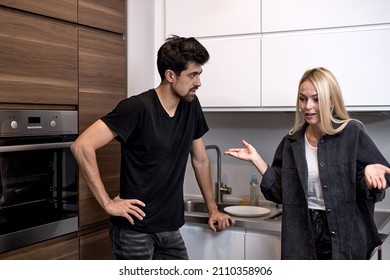 Tired Frustrated Wife Ignoring Angry Bearded Husband Arguing Blaming Upset Man Of Problems, Jealous Woman Shouting At Sad Male, Family Fight And Controlling Boyfriend, Disrespect. In Kitchen