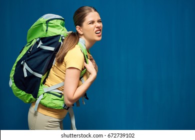 Tired Girl With Heavy Backpack On Blue Background.