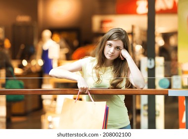 Tired Girl With Shopping Bags In Mall 