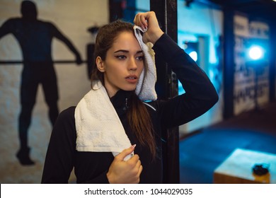 Tired Girl Wiping Sweat With Towel In Gym.