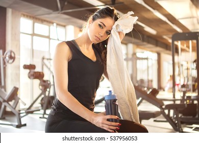 Tired Girl Wiping Sweat With Towel In Gym.