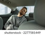 Tired handsome man sleeping in his modern car