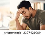 Tired, headache and stress of man in living room with mental health, fatigue and sad problem. Face, depression and frustrated male person with anxiety, brain fog or crisis of failure, mistake or debt