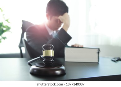 Tired lawyer sitting on desk