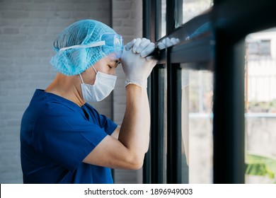 Tired male medical worker working over hours at hospital. Asian overworked professional feeling sleepy and exhausted during COVID-19 Pandemic outbreak. Stressed and depressed nurse and doctor - Powered by Shutterstock