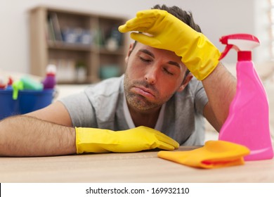 Tired Man With Cleaning Equipment