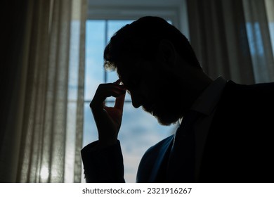 Tired man having a terrible headache. Exhausted man feeling unhealthy, upset about headache illness. Stressed middle-aged man having headache. Migraine and headache concept. - Powered by Shutterstock