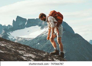 Tired Man in mountains with backpack Norway Travel lifestyle hiking hard trek concept adventure summer vacations - Powered by Shutterstock