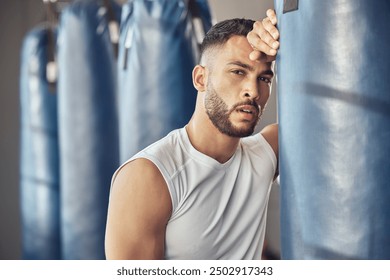 Tired man, portrait and boxer with punching bag for self defense training, practice or martial arts at gym. Exhausted male person or fighter in fitness for break after intense exercise or boxing - Powered by Shutterstock