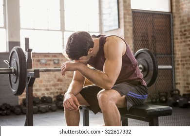 Tired Man Sitting On The Bench At The Gym