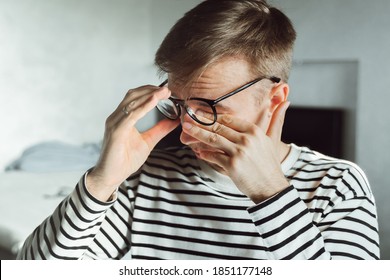 Tired Man Taking Off Glasses Rubbing Dry Irritated Eyes To Relieve Pain Feeling Discomfort Suffers Eye Strain, Poor Blurry Vision Isolated On White Background, Organ Of Sight Fatigue. Tiredness, Pain