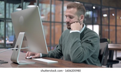 Tired Man Trying To Stay Awake Doing Working On Computer