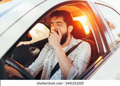 Tired Man Yawning While Driving His Car