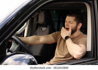 Tired Man Yawning While Driving His Modern Car