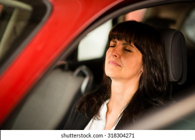 Tired Mature Business Woman Sitting In Car And Relaxing With Closed Eyes - View Through Side Window