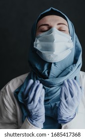 tired medical worker doctor woman muslim woman in hijab praying after taking a large number of patients due to epidemic of coronavirus