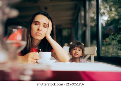 
Tired Mom In Desperate Need Of A Cup Of Coffee In A Restaurant. Mother Feeling Sleepy And Exhausted Exasperated By Overworking Schedule 
