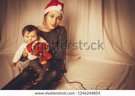 tired mother with baby at christmas time