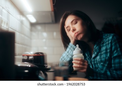 Tired Mother Holding A Milk Baby Bottle At Night. Exhausted Sleepy Mom Preparing Formula For Night Feeding The Newborn 
