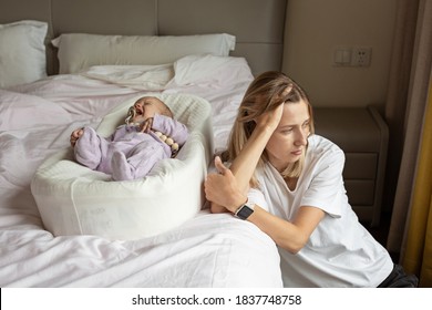 Tired Mother Suffering from experiencing postnatal depression. Health care mom motherhood stressful. Stay at home during coronavirus covid-19 pandemic quarantine