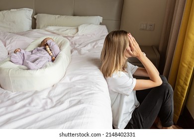 Tired Mother Suffering from experiencing postnatal depression. Health care mom motherhood stressful. Stay home during coronavirus covid-19 pandemic quarantine